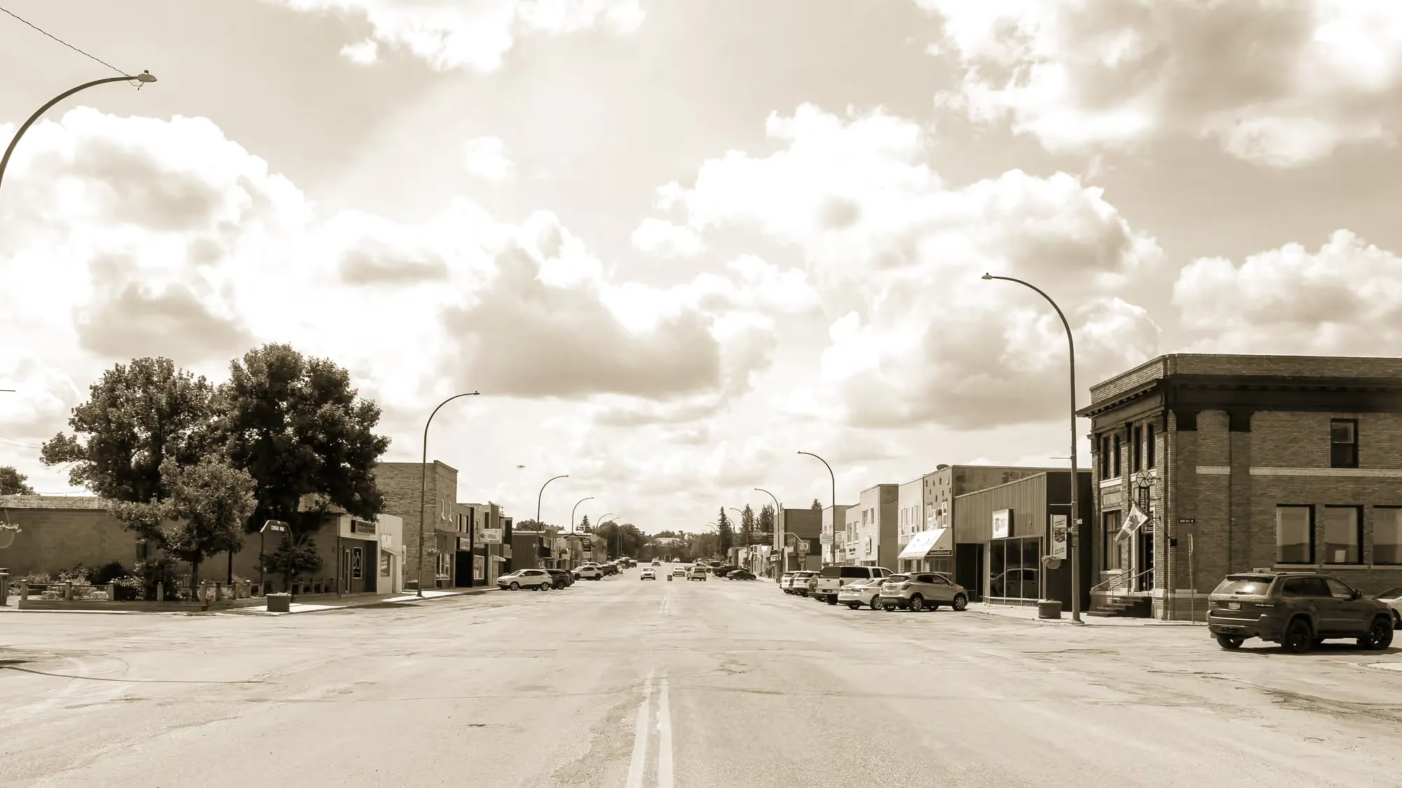 Downtown Centre Street in Assiniboia, Saskatchewan — the heritage brick bank building anchoring the corner